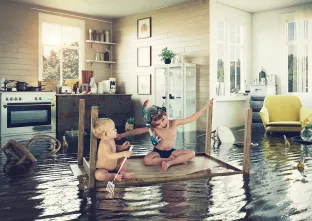 two children on table raft in flooded kitchen